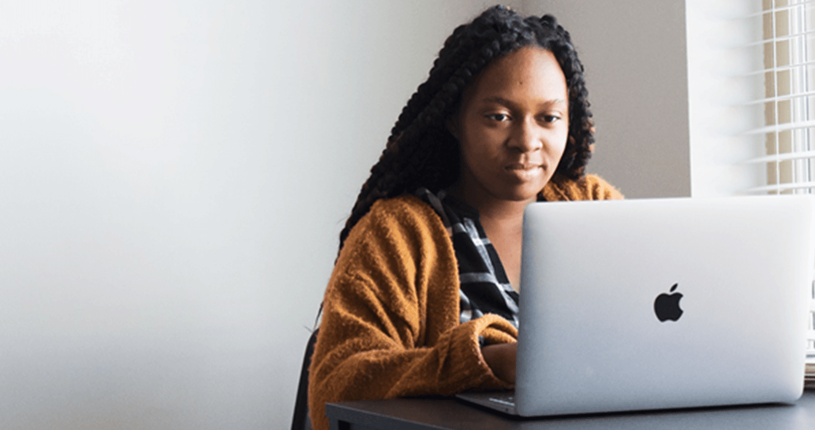 woman making a claim on laptop because she was mis sold a car finance loan
